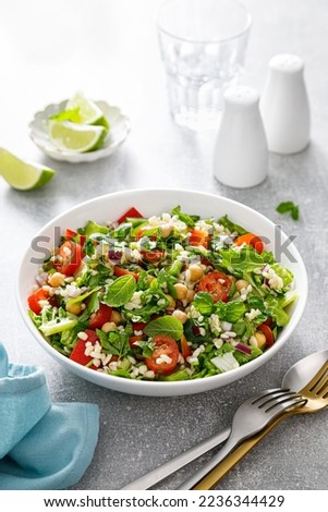 Tabbouleh salad. Tabouli salad with fresh parsley, onions, tomatoes, bulgur and chickpea. Healthy vegetarian food, mediterranean diet