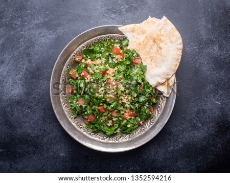 Tabbouleh salad is a traditional middle eastern or arab dish. Vegetarian salad with parsley, mint, bulgur, tomato. It can be eaten as food for iftar on Ramadan