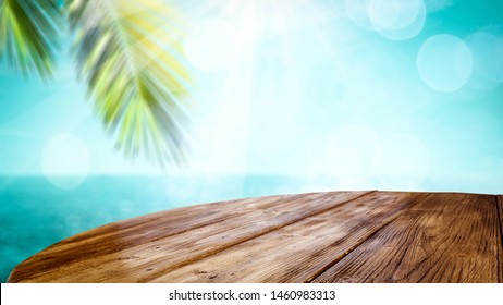 Table Background With Beautiful Blue Ocean And Sandy Beach View. A Table Top And The Sea In Distance. Summer Sunny Day.