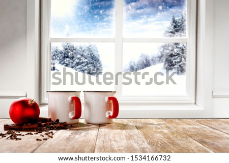Table background of free space and chrsitmas winter window background. 