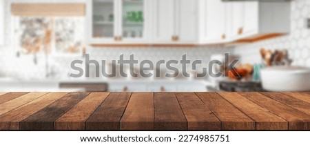 Table background of free space and kitchen interior.White wall with shadows and sunny warm morning time.Copy space for your composition, Easter table with spring flowers in a sunny April kitchen.