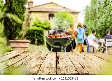 Table background of free space for your your decoration with blurred background with grill party and few people. 