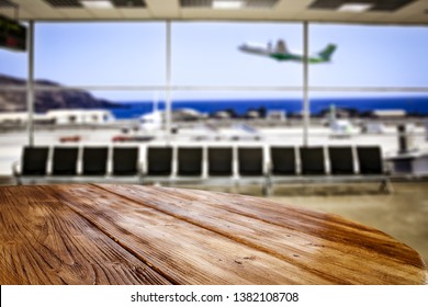 Table background of free space for your decoration and airport background with planes 