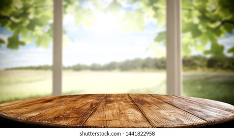 Table background of free space for your decoration and blurred background of window. Summer time. 