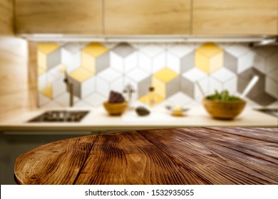 Table background of free space for your decoration and blurred furniture of kitchen. Chritmas time in home. 
