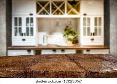 Table background of free space for your decoration and blurred furniture of kitchen. Chritmas time in home.