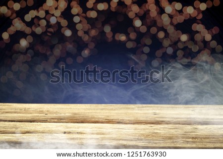 Table background of free space for your decoration and smoke with dark blue bokey space 