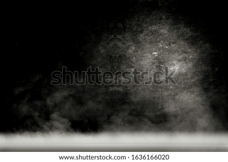 Table background of free space for your product and black blurred background.Copy space and smoke decoration. 