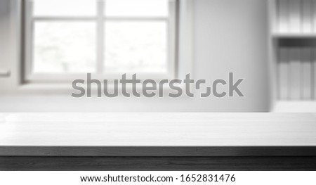 Table background of free space for your decoration and whte home interior with big window.Spring time and sunny day. 