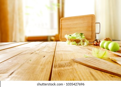 Table background in kitchen with big blurred window and easter eggs on top. Free space for your decoration. 