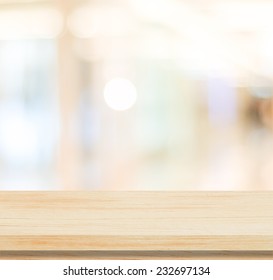 Table and blur background, Wooden counter over blur bokeh light background, Brown wood table top, shelf for food and retail shop, store product display backdrop, banner, mockup, template  - Shutterstock ID 232697134
