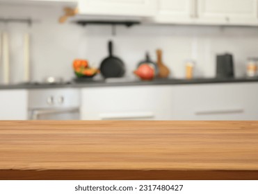 Table with blurred kitchen background - Shutterstock ID 2317480427