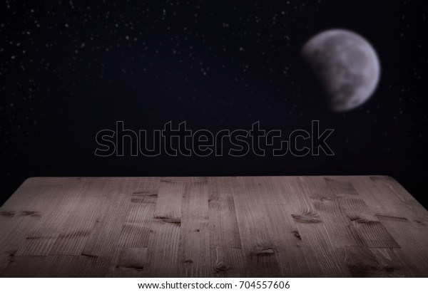 table of boards background of the night with the\
moon and stars.