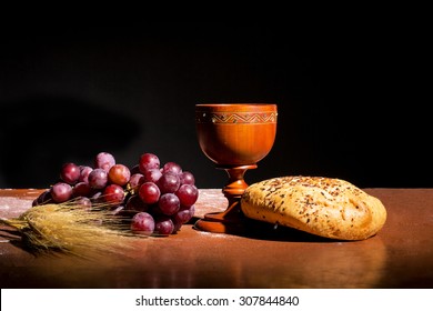 table with bread, wine, wheat and grapes for the consecration