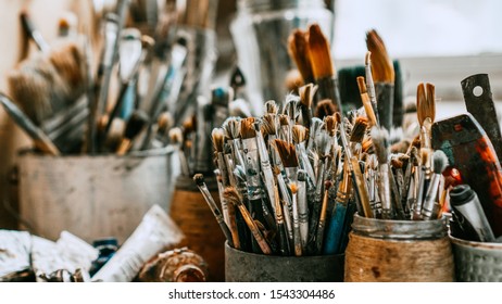 Table with brushes and tools in an art workshop. Background. - Powered by Shutterstock