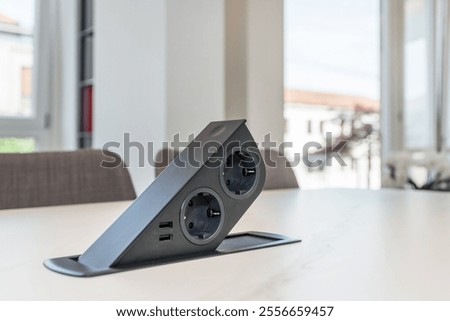 Table built-in socket. Fixed retractable power strip for home and office. New technology. Modern style.