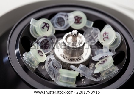 Table centrifuge filled with tubes. Spin column-based nucleic acid purification technique.