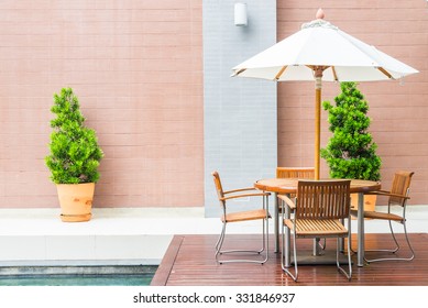 Table And Chair With White Umbrella Outdoor Patio