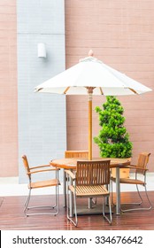 Table And Chair With White Umbrella Outdoor Patio