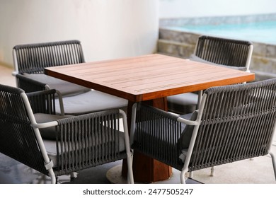 table and chairs beside blur pool, outside - Powered by Shutterstock