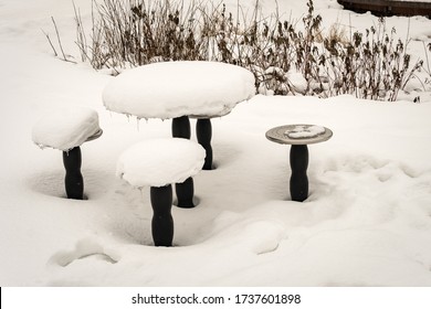 Table And Chairs Covered With Snow Outside In A Park During The Winter. Taken In Anchorage, Alaska. Too Cold To Eat Out On A Field. Modern Dining Room. 