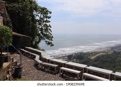 table and chairs facing the sea view