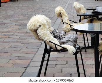 Table And Chairs With Fur Cape Outdoors Near The Restaurant