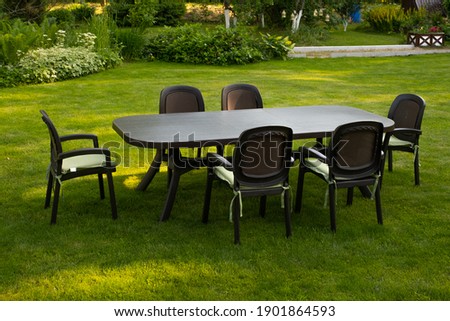 Table and chairs in garden. Selective focus