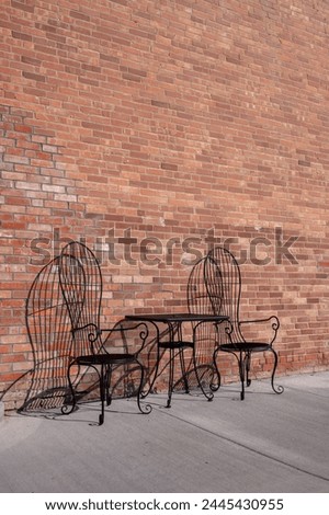 Table and chairs at an ld brick storefront in downtown Granum.
