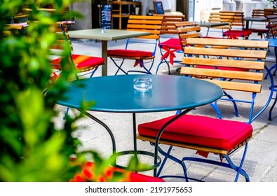 table and chairs at a sidewalk cafe - photo