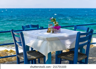 Table And Chairs In A Typical Tavern By The Sea At Rethymnon, Crete, Greece - Shutterstock ID 211731103