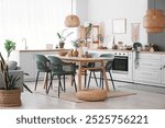 Table, chairs and wicker pouf near counter in interior of dining room