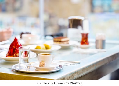 Table with coffee and cake lit from the window