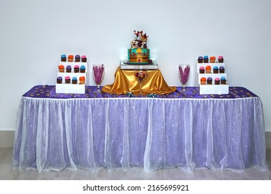 table decorated Aladin's birthday cake and candles, cupcakes	 - Shutterstock ID 2165695921