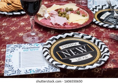 Table Decorated For New Year Celebration With, Food, Red Wine, Plate That Say 