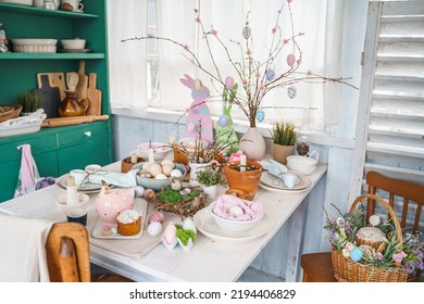 Table Decoration For Easter Celebration In Kitchen.Tablescape For Easter Holiday At Home.Family Religious Traditional Festive Christianity,catholic Meal Food.Pop Color Eggs,cake,fun Bunny,candy Sweet.