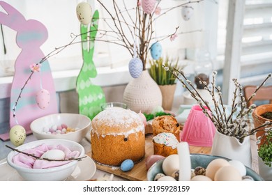 Table Decoration For Easter Celebration In Kitchen.Tablescape For Easter Holiday At Home.Family Religious Traditional Festive Christianity,catholic Meal Food.Pop Color Eggs,cake,fun Bunny,candy Sweet.