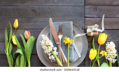 Table Decoration On Gray Wooden Boards With Spring Flowers And A Little Gift For A Mothers Day Dinner In Vintage Style