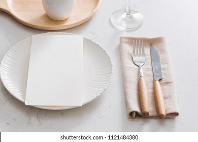 Table decoration. White plates, fork, knife on grey stone plate - Shutterstock ID 1121484380