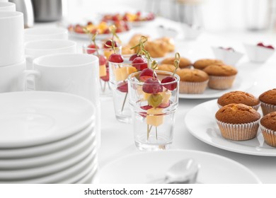 Table with different delicious snacks and dishware indoors. Coffee break - Shutterstock ID 2147765887