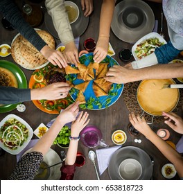 Table of enjoying food with family and friends top view - Shutterstock ID 653818723