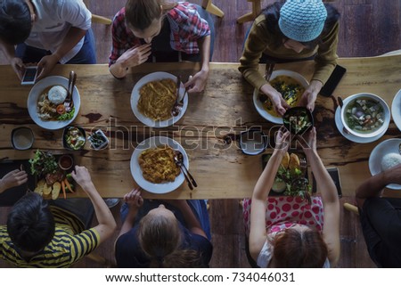 Similar – Image, Stock Photo Young friends looking map with healthy drinks and snacks