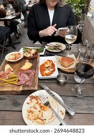 Table filled with dinner plates while dinning outside 
