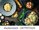 The table is filled with dishes and food. A set of salads, pasta and snacks. Food background.