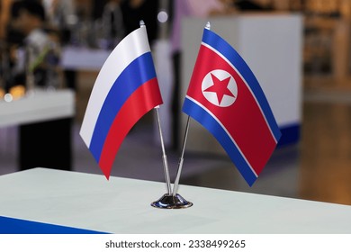 Table flags of the Russian Federation and North Korea together at some event or fair. Flags of the two countries as a symbol of cooperation between states. Joint business of North Korea and Russia - Shutterstock ID 2338499265
