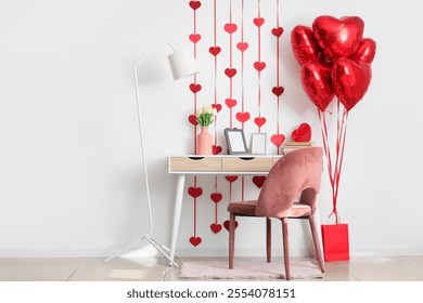 Table, floor lamp, chair and heart-shaped balloons near white wall in room. Valentine's Day celebration - Powered by Shutterstock