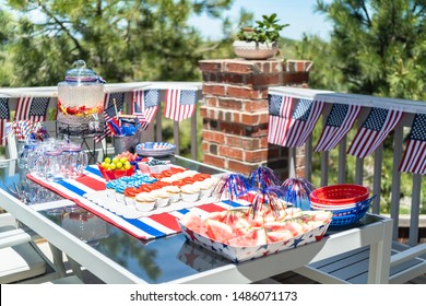 Table With Food And Drinks Set For Celebrating July 4th On The Back Patio.