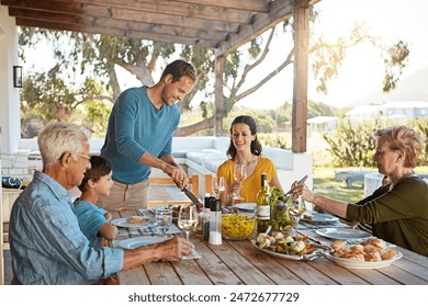 Table, food and family outdoors for lunch, supper and eating meal in backyard together. Celebration, parents and children with dish for bonding, relax and talking for nutrition, health and wellness - Powered by Shutterstock