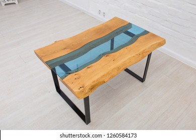 Table in the form of a river of blue glass in the style of lively