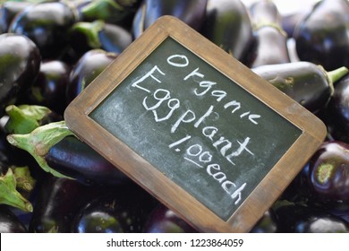 Table Of Fresh Organic Eggplants With Chalkboard Price Sign At Madison Wisconsin Farmers Market 